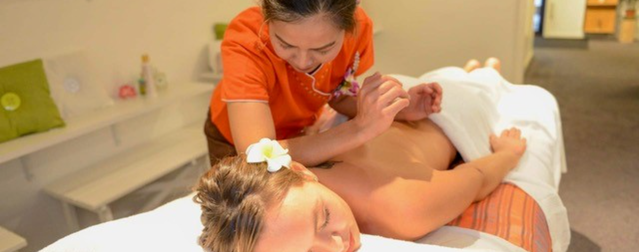 Therapist providing a traditional Thai body massage